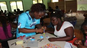 Trainer assisting one of the Beneficiaries 1JPG